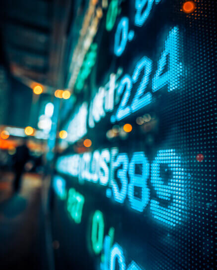 Financial stock market numbers and city light reflection